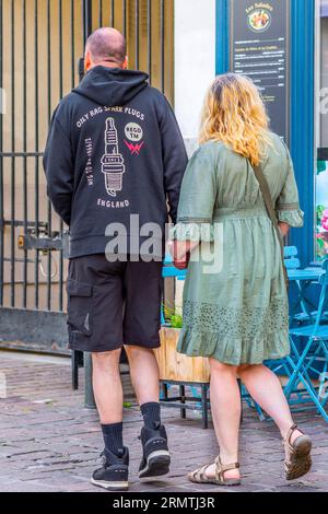 Back view of English couple walking in city center hand in hand - Tours, Indre-et-Loire (37), France. Stock Photo