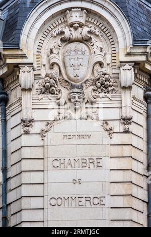 1924 architectural detail in stonework above Chamber of Commerce building  - Tours, Indre-et-Loire (37), France. Stock Photo