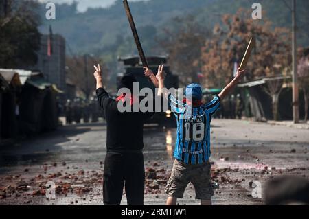 (140907) -- SANTIAGO, Sept. 7, 2014 -- People take part in a clashes on the 41st anniversary of the military coup that brought Augusto Pinochet to power, in Santiago, capital of Chile, on Sept. 7, 2014. By the end of Pinochet s regime in 1990, 200,000 Chileans were driven into exile, 40,000 were tortured by the security apparatus, and more than 3,000 were executed or remain unaccounted for in the country. Jorge Villegas) (vf) (ah) CHILE-SANTIAGO-SOCIETY-CLASHES e JORGExVILLEGAS PUBLICATIONxNOTxINxCHN   Santiago Sept 7 2014 Celebrities Take Part in a clashes ON The 41st Anniversary of The Milit Stock Photo
