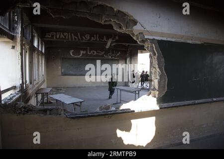 Palestinian students are seen inside their damaged classroom on the first day of the school year in al-Sheiaeiya neighborhood in the east of Gaza City, on Sept 14, 2014. School year started in the Gaza Strip on Sunday after a three-week delay due to severe destruction of schools caused by an Israeli large-scale offensive waged on the enclave that ended on Aug. 26. ) MIDEAST-GAZA-STUDENTS-SCHOOL-FIRST DAY WissamxNassar PUBLICATIONxNOTxINxCHN   PALESTINIAN Students are Lakes Inside their damaged Classroom ON The First Day of The School Year in Al  Neighborhood in The East of Gaza City ON Sept 14 Stock Photo