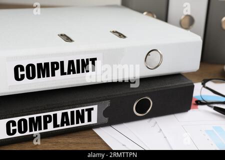 Folders with Complaint labels on office desk, closeup Stock Photo