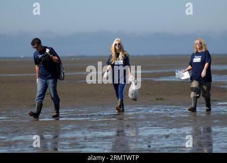 (140920) -- RICHMOND, Sept. 20, 2014 -- Volunteers clean the beach and surrounding area during the annual Great Canadian Shoreline Cleanup at Iona Beach Regional Park in Richmond, BC, Canada, on Sept. 20, 2014. Over 35,000 Canadians have signed up to take part in one of the largest direct action conservation programs, as well as the most significant contributor to the International Coastal Cleanup in Canada. Last year s Shoreline Cleanup saw over 3,000 Kilos picked up across the country with 500 kilos removed from Richmond s Iona Beach. ) CANADA-RICHMOND-SHORELINE-CLEANUP SergeixBachlakov PUBL Stock Photo