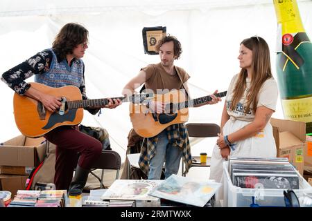 Spencer Cullum, Sean Thompson and Erin Rae play the merch tent at Green Man Festival in Wales, UK, August 2023. Photo: Rob Watkins Stock Photo