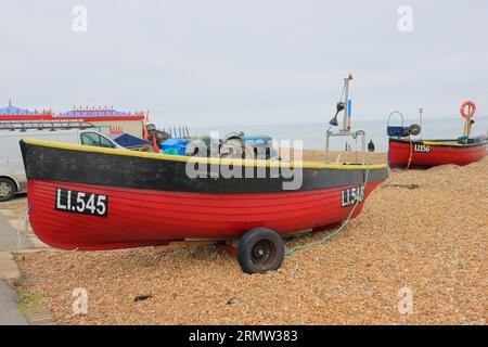 Seafront, Bognor Regis, West Sussex, England. 11th February 2023. Colour: A red yellow and black lifeboat on the gravel beach, number Li.545. Stock Photo