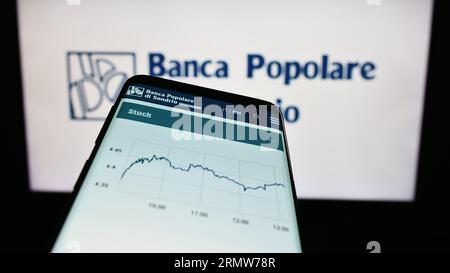 Smartphone with webpage of Banca Popolare di Sondrio S.C.p.A. (BPSO) on screen in front of business logo. Focus on top-left of phone display. Stock Photo