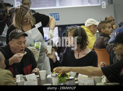 (141013) -- VANCOUVER, Oct. 13, 2014 -- People enjoy a free Thanksgiving dinner in Vancouver, Canada, Oct. 13, 2014. Over 3,000 people suffering from poverty and homelessness in metro Vancouver area are offered free meal by Union Gospel Mission here for Canadian Thanksgiving Day. ) CANADA-VANCOUVER-THANKSGIVING-CHARITY LiangxSen PUBLICATIONxNOTxINxCHN   Vancouver OCT 13 2014 Celebrities Enjoy a Free Thanksgiving Dinner in Vancouver Canada OCT 13 2014 Over 3 000 Celebrities Suffering from Poverty and Homeless Ness in Metro Vancouver Area are offered Free Meal by Union Gospel Mission Here for Ca Stock Photo