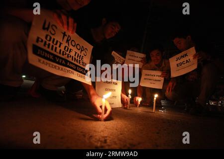 (141014) -- MANILA, Oct. 14, 2014 -- Activists light candles during a candlelighting rally in Manila, Philippines on Oct. 14, 2014. The Philippine government on Tuesday vowed justice for a Filipino transgender who was found dead in a hotel in Olongapo City in northern Philippines. A U.S. Marine, identified as Private First Class Joseph Scott Pemberton, was tagged as a possible suspect in the murder of Jeffrey Laude. ) (cy) PHILIPPINES-MANILA-CANDLELIGHTING RALLY RouellexUmali PUBLICATIONxNOTxINxCHN   Manila OCT 14 2014 activists Light Candles during a Candle Lighting Rally in Manila Philippine Stock Photo