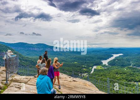 Chimney Rock, North Carolina, USA - August 11, 2023: Tourst at the top of Chimney Rock at Chimney Rock State Park. Stock Photo