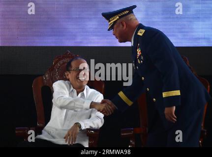 (141016) -- MANILA, Oct. 16, 2014 -- Philippine President Benigno Aquino III (L) shakes hands with Philippine Coast Guard (PCG) Commandant Vice Admiral Rodolfo Isorena during the PCG 113th anniversary celebration in Manila, the Philippines, Oct. 16, 2014. The PCG will acquire 15 new ships from Japan and France, 2 medium-size light helicopters, 300 additional aluminum boats, 40 rubber boats, 36 staff vehicles and 46 lighthouses, in celebration of its 113th anniversary. ) PHILIPPINES-MANILA-COAST GUARD-ANNIVERSARY RouellexUmali PUBLICATIONxNOTxINxCHN   Manila OCT 16 2014 Philippine President Ben Stock Photo