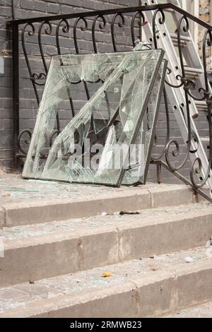 Missile attack in Kyiv, Ukraine, august 2023. Broken windows and shuttered glass on stairs after explosion. House damaged by blast wave War in Ukraine Stock Photo