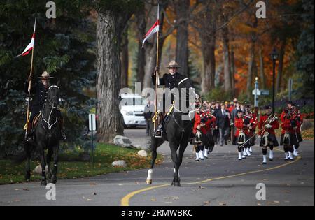 Royal Canadian Mounted Police ride horses through the RCMP National Memorial Cemetery in Ottawa, Canada, on Oct. 19, 2014. The cemetery, open to retired and current members of the RCMP, civilian members, special constables, and members of their families, was celebrated on Sunday for the 10th anniversary of the cemetery.Cole Burston)(wxl) CANADA-OTTAWA-RCMP-MEMORIAL CEMETERY-ANNIVERSARY libaodong PUBLICATIONxNOTxINxCHN   Royal Canadian Mounted Police Ride Horses Through The RCMP National Memorial Cemetery in Ottawa Canada ON OCT 19 2014 The Cemetery Open to Retired and Current Members of The RC Stock Photo