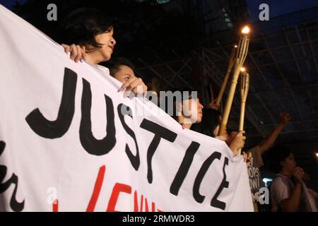 Activists hold torches as they call for justice during a protest rally in Manila, Philippines on October 24, 2014. The protesters demanded justice for Filipino transgender Jeffrey Laude who was allegedly killed by US Marine Private First Class Joseph Scott Pemberton. ) PHILIPPINES-MANILA-PROTEST RouellexUmali PUBLICATIONxNOTxINxCHN   activists Hold torches As They Call for Justice during a Protest Rally in Manila Philippines ON October 24 2014 The protesters demanded Justice for Filipino Transgender Jeffrey Laude Who what allegedly KILLED by U.S. Navy Private First Class Joseph Scott Pemberton Stock Photo