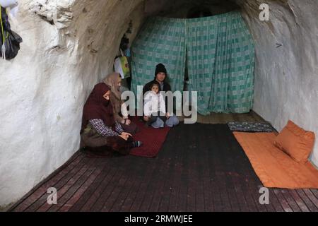 (230830) -- BEIJING, Aug. 30, 2023 (Xinhua) -- This photo taken on Feb. 8, 2023 shows residents in a cave-turned shelter next to the Buddha site in central Afghanistan's Bamyan province. (Photo by Saifurahman Safi/Xinhua) Stock Photo