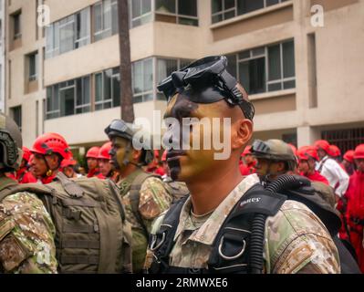 Lima, Peru - July 29 2023: Young Peruvian Man with Black and Green Face paint, Wearing Camouflage Clothing and a Bulletproof Vest, Stands at Attention Stock Photo