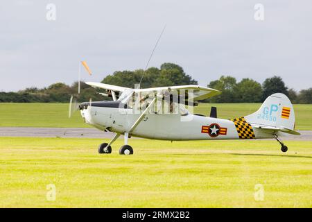 Cessna 305c, Bird Dog, G-PDOG taking off from the grass. Stock Photo