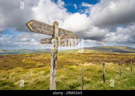 Pennine Way signpost on the England Scotland border in the Cheviot Hills, Northumberland National Park Stock Photo