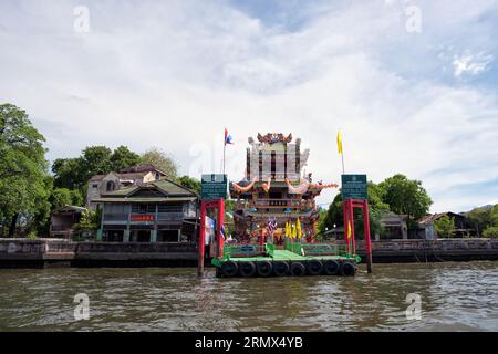 Chao Praya, Thailand - June 1, 2019: Scenic view of cityscape, temple and boats along the Chao Praya River in Bangkok, Thailand. - Popular tourist boa Stock Photo