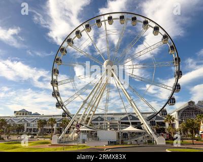 The Cape Wheel is a 40 meter observation wheel featuring 30 enclosed cabins with sweeping views of Granger Bay, Robben Island and Table Mountain Stock Photo