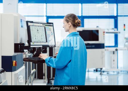 Manufacturing worker checking data of assembly line on screen Stock Photo