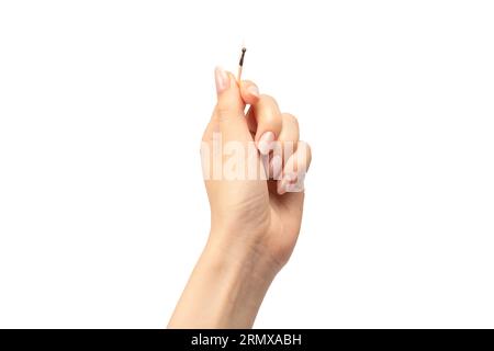 Lit match in a woman hand isolated on a white background. Copy space. Stock Photo