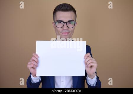 Smiling Young Handsome Elegant Man Holding White Paper on Copy Space on Isolated Background Stock Photo