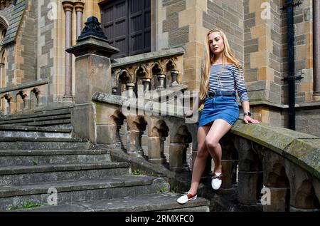 Rhianna Martin, a stunning blonde woman at Dundee's McManus art gallery and museum, enjoys the pleasant weather in Scotland, UK. Stock Photo