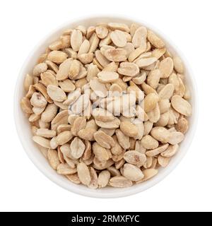 Salted peeled peanuts in a white plate on a white background. View from above. Nuts in a bowl Stock Photo