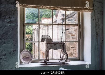 Wooden horse on windowsill of 18th century flower loft conversion near Penzance in Cornwall, UK Stock Photo