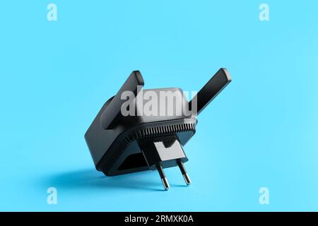 Black WiFi repeater on blue background Stock Photo