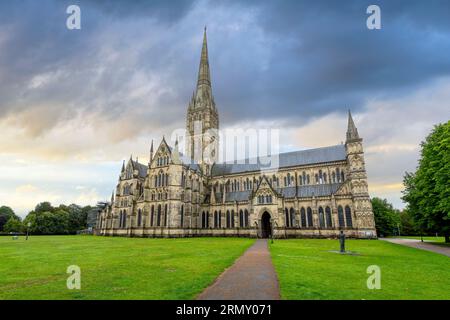 The medieval Salisbury Cathedral, formally the Cathedral Church of the Blessed Virgin Mary, under stormy skies at dusk in Salisbury, England, UK. Stock Photo