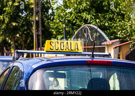 Driving school sign placed on top of car Stock Photo