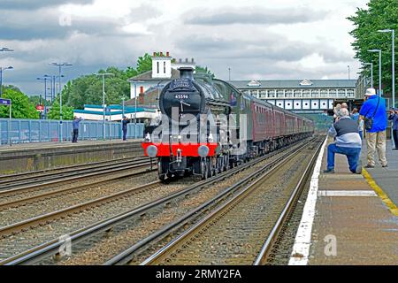 The steam hauled Dorset Coast Express excursion hurries through Eastleigh Hampshire on it's way from London Victoria to the seaside town of Weymouth. Stock Photo