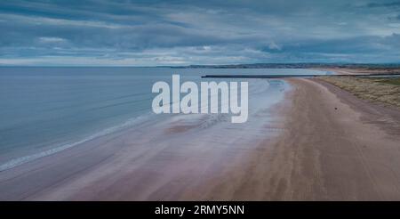 Aerial drone picturesque panorama of sandy beach at Castlerock, Northern Ireland on cloudy spring day. Dark clouds, wind and low tide at Castlerock co Stock Photo