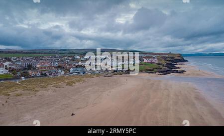 Aerial drone picturesque panorama of sandy beach at Castlerock, Northern Ireland on cloudy spring day. Dark clouds, wind and low tide at Castlerock co Stock Photo