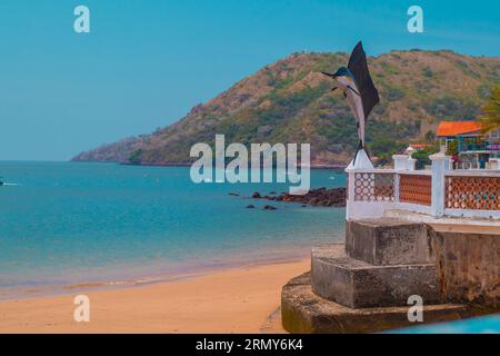 Beautiful island of Taboga, close to Panama city. View of the coastal town and a local landmark a statue of a fish. Stock Photo