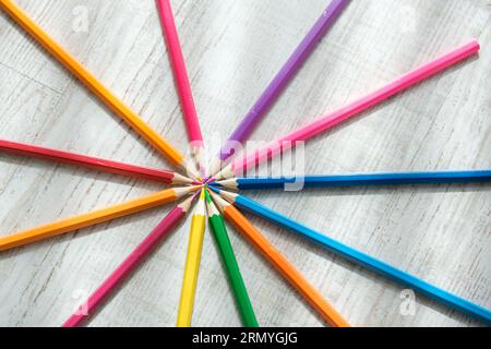 Coloured pencils arranged in a circle on Coloured pencils arranged in a circle on a wooden background. High quality photo Stock Photo