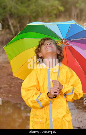Child standing in the puddle in yellow rubber boots Stock Photo - Alamy