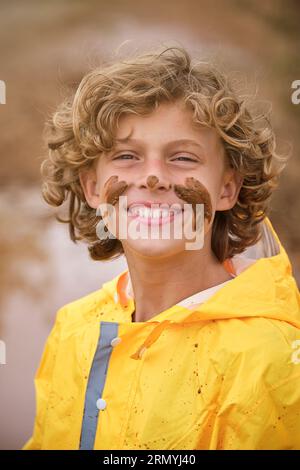 Child standing in the puddle in yellow rubber boots Stock Photo - Alamy