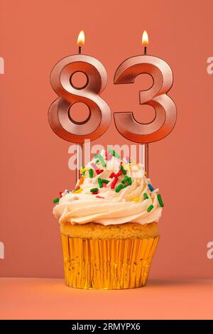 Birthday cake with candle number 83 - Coral fusion background Stock Photo