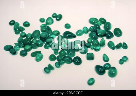 Green emeralds from Muzo, Coscuez and Chivor Colombia, isolated on white background Princess cut jewel Round cut jewel Emerald cut jewel Oval jewel, C Stock Photo
