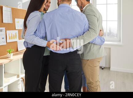 Group of business people bonding in circle, view form behind Stock Photo