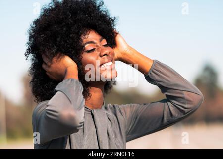 beautiful model of color smiling, dancing with a lot of joy and positivity Stock Photo
