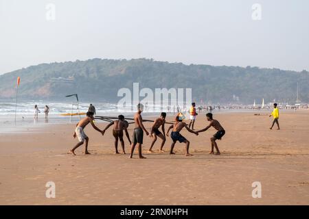 Calangute, Goa, India - January 2023: A group of young Indian men playing kabaddi on the beach in Goa. Stock Photo