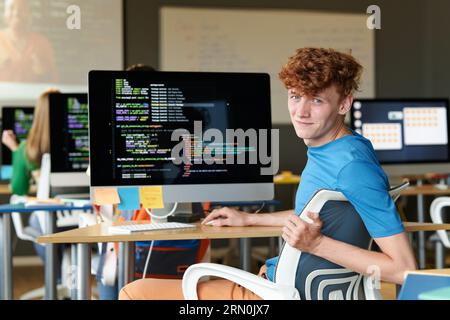 Portrait of student looking at camera while using computer at IT lesson Stock Photo