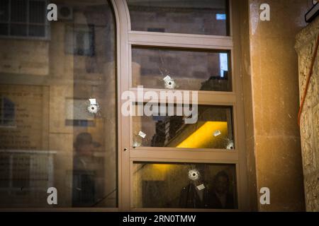 (141119) -- JERUSALEM,  -- Bullet holes are seen in the attacked synagogue s front glass during the funeral of Aryeh Kopinsky, Calman Levine and Avraham Shmuel Goldberg near the scene of the attack at a synagogue in the Har Nof neighborhood of Jerusalem, on Nov. 18, 2014. Israeli Prime Minister Benjamin Netanyahu accused the Palestinian Authority of incitement as triggering the deadly attack on a Jerusalem synagogue Tuesday and urged the international community to denunciate terror and end Palestinian incitement. ) MIDEAST-JERUSALEM-SYNAGOGUE-ATTACK-FUNERAL JINI PUBLICATIONxNOTxINxCHN   Jerusa Stock Photo