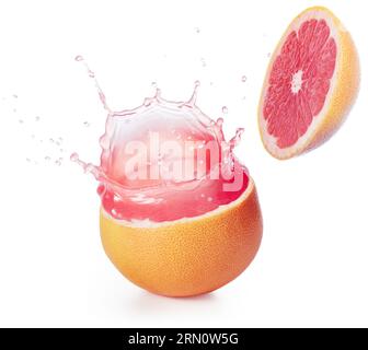 Fresh pink juice spilling out of a cut grapefruit isolated on white background. Authentic studio shot. Stock Photo