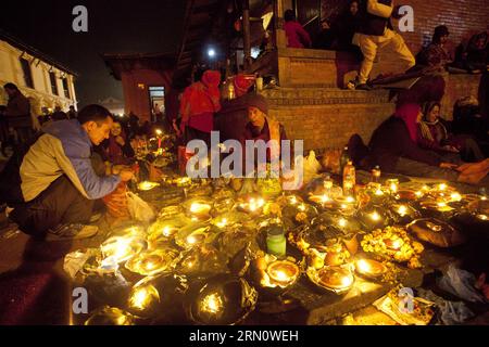 (141121) -- KATHMANDU, Nov. 21, 2014 -- Nepalese Hindu devotees light oil lamps during Bala Chaturdashi festival at the Pashupatinath temple in Kathmandu, Nepal, Nov. 21, 2014. Bala Chaturdashi is celebrated in memory of departed family members by lighting oil lamps and scattering seven types of grain along a prescribed route. ) (lmz) NEPAL-KATHMANDU-BALA CHATURDASHI-CELEBRATION PratapxThapa PUBLICATIONxNOTxINxCHN   Kathmandu Nov 21 2014 Nepalese Hindu devotees Light Oil lamps during Balanchine Chaturdashi Festival AT The Pashupatinath Temple in Kathmandu Nepal Nov 21 2014 Balanchine Chaturdas Stock Photo