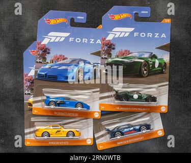 Doha, Qatar - August 17, 2023: Assortment of Hot Wheels die cast carded car model for Hot Wheels series. Hot Wheels is a scale die-cast toy cars by Am Stock Photo