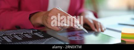 Business woman analyzing charts and diagrams on digital tablet Stock Photo