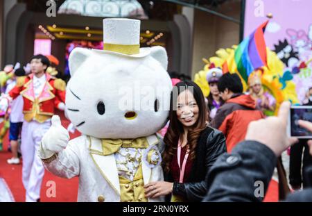 (141128) -- ANJI, Nov. 28, 2014 -- A guest poses for photo with a staff member in a cartoon character outfit during a ceremony marking the completion of a Hello Kitty theme park in Anji, east China s Zhejiang Province, Nov. 28, 2014. The first of its kind in China, the Hello Kitty theme park in Anji is scheduled to open on Jan. 1, 2015, as more than a million visitors are expected per year. ) (lmm) CHINA-ZHEJIANG-ANJI-HELLO KITTY-THEME PARK-COMPLETION (CN) XuxYu PUBLICATIONxNOTxINxCHN   Anji Nov 28 2014 a Guest Poses for Photo With a Staff member in a Cartoon Character Outfit during a Ceremony Stock Photo